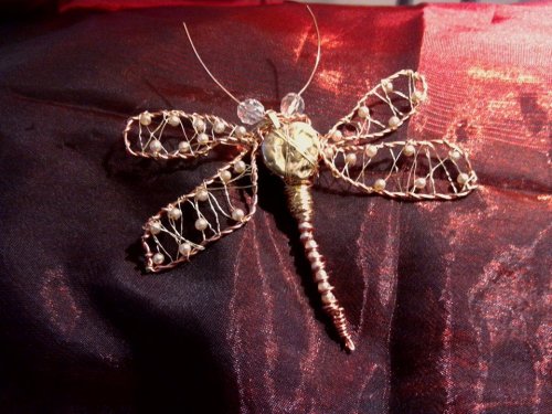This is made from copper wire, upcycled wire from wine bottles, cultured pearls from an old necklace and an old battered locket.  Again, this refuses to fly but will hover if held with a piece of string.   